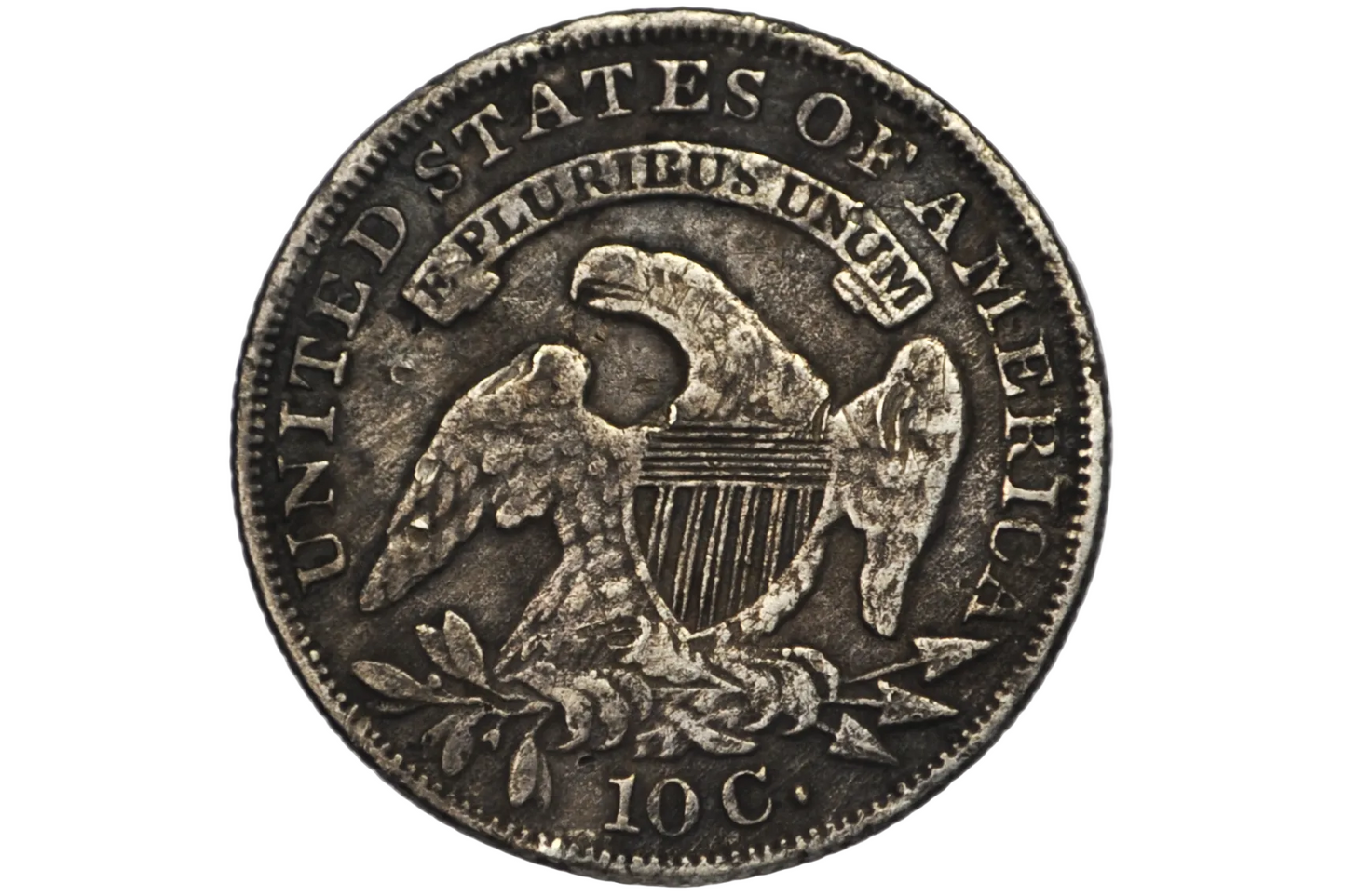 Reverse of an 1835 US Dime featuring an eagle with sprigs and arrows in tallons and a shield on it's breast.