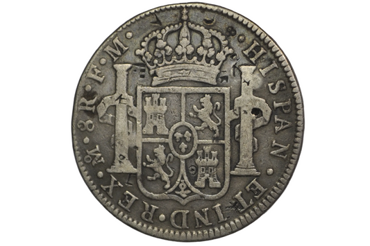 Reverse of a panish 8 reales from 1789. Two pillars on either side of a crest that is topped by a crown above. Lettering: Mo.8R.F.M. Hispan. ET IND.REX