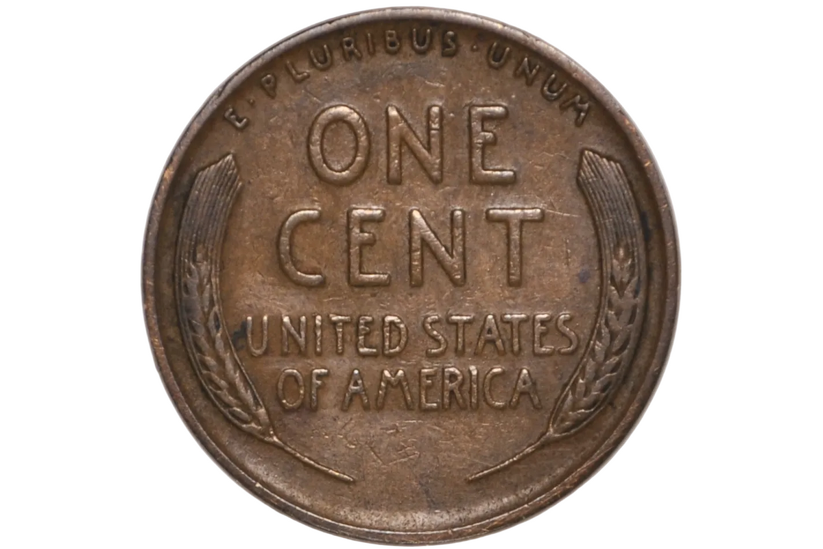 A vintage United States one cent coin displayed inside a clear plastic protective capsule, showing the obverse side with 'ONE CENT', 'UNITED STATES OF AMERICA', and wheat wreath details.