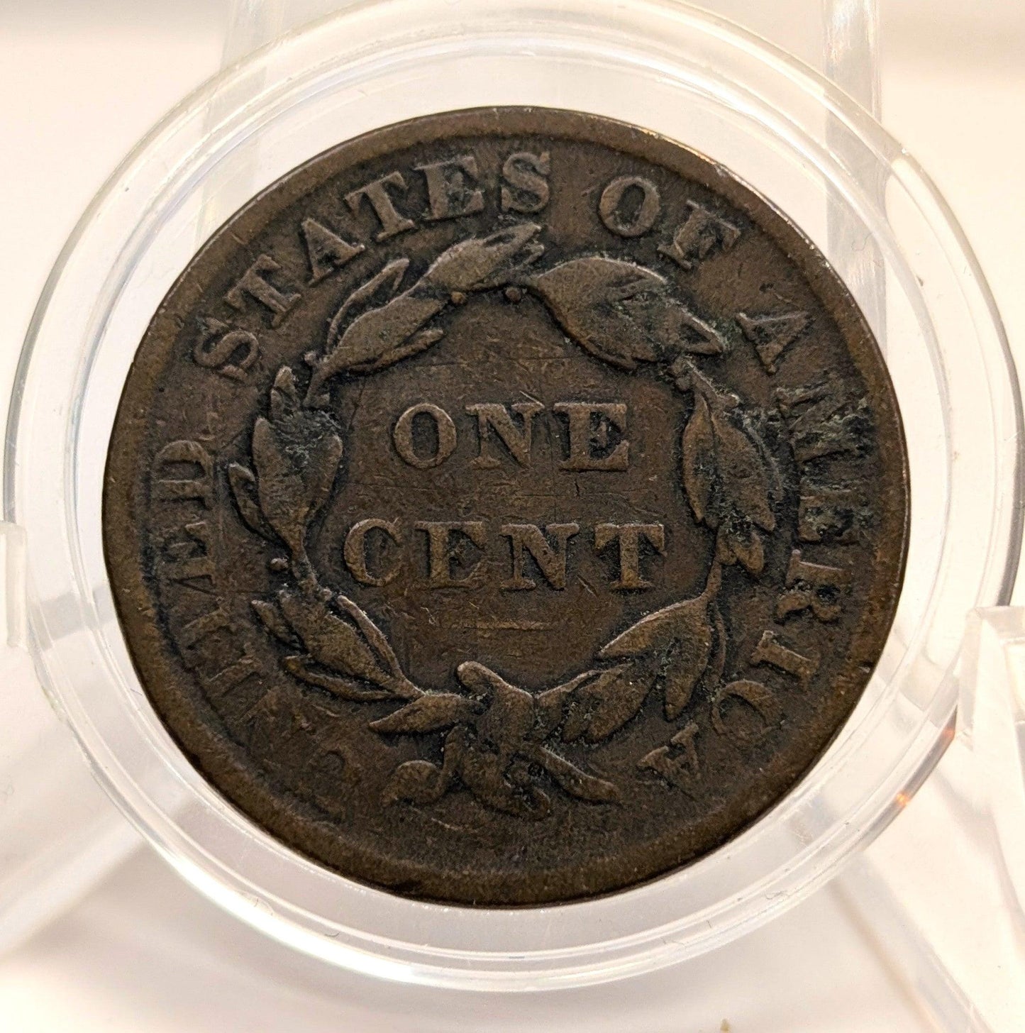 Vintage one cent coin from the United States of America in a clear protective case.