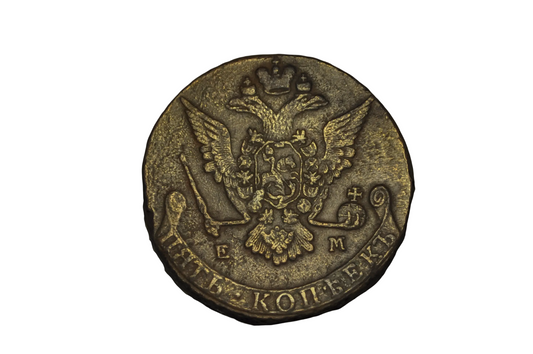 Old coin with an eagle emblem and text on a black background