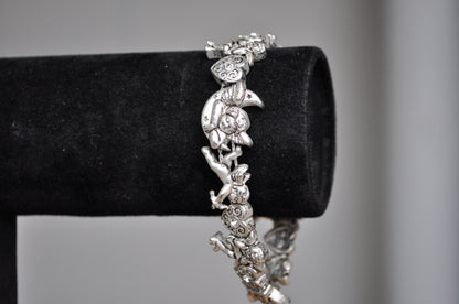 Cute Avon Valentines Day Silver Tone Cupid Bracelet - 8.5 Inches - Angel/Cupid/Cherub Bracelet - Adorned with Rhinestone Hearts