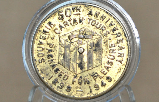 "Packaged for Pleasure" 50th Anniversary Cartan Tours Souvenir Token - Cartan Tours Anniversary, Goodluck, and Spinner Token