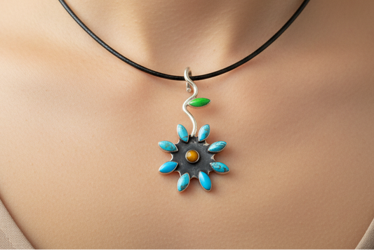 Silver pendant with turquoise stones resembling a flower