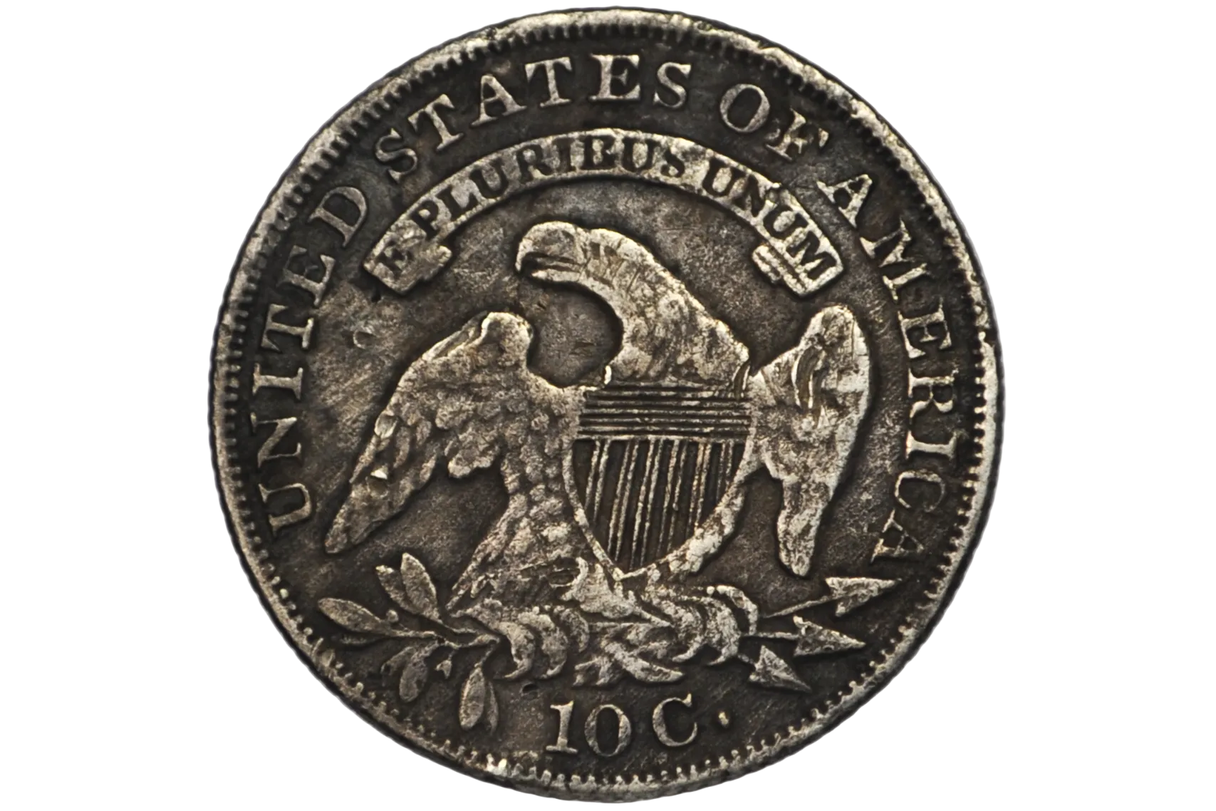 Reverse of an 1835 US Dime featuring an eagle with sprigs and arrows in tallons and a shield on it's breast.