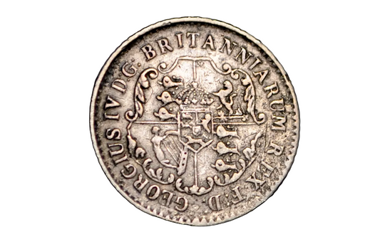Silver coin with intricate design and text on a black background from 1822