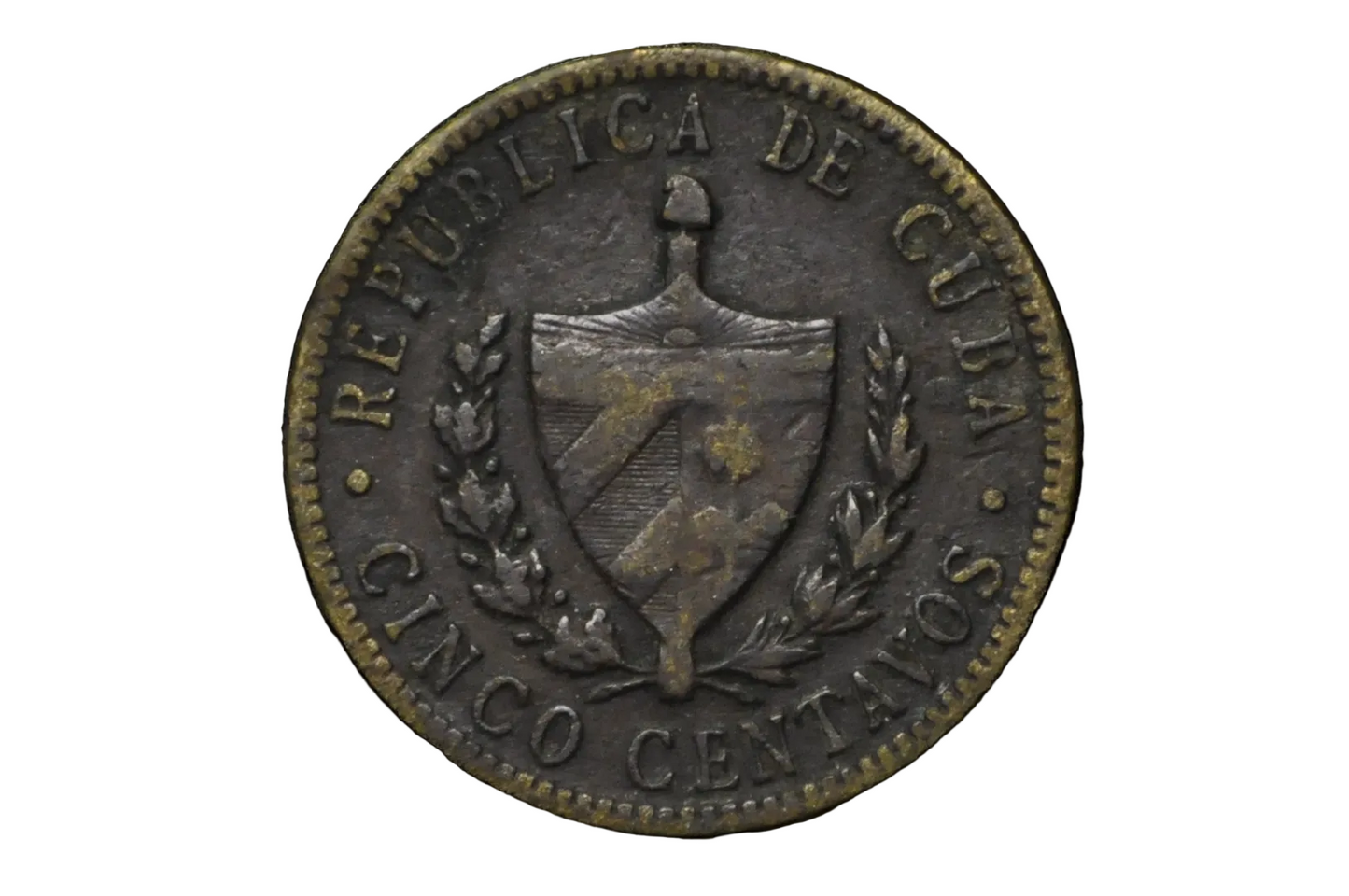 Old coin with 'Republica de Cuba' text and shield design on a black background