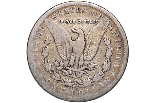 A silver US one dollar coin featuring the Great Seal with an eagle, laurel wreath, and the text 'In God We Trust' and 'United States of America', displayed inside a clear plastic protective capsule.