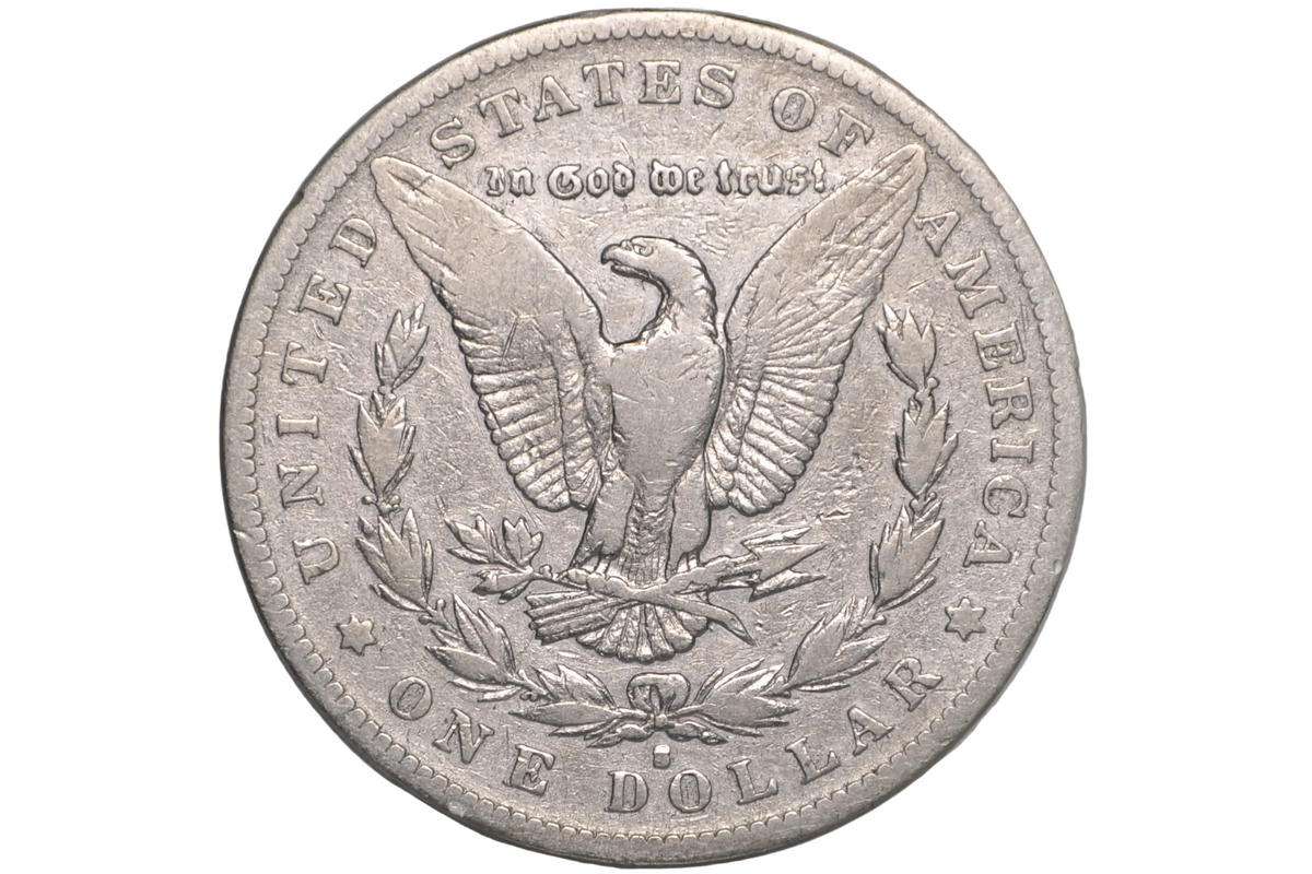 A silver US one dollar coin featuring an eagle and the text 'In God We Trust' and 'United States of America', displayed inside a clear plastic protective capsule.