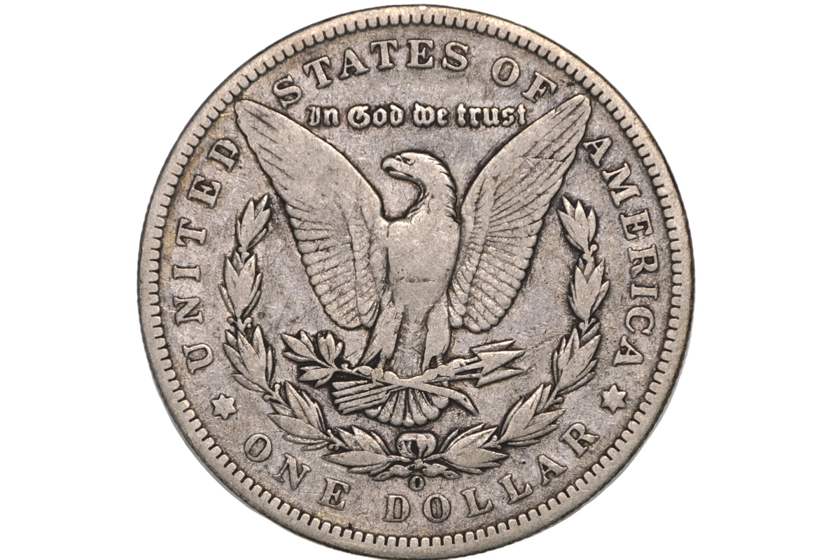 A silver United States one dollar coin featuring the eagle design and 'In God We Trust' inscription, displayed inside a clear plastic protective capsule.