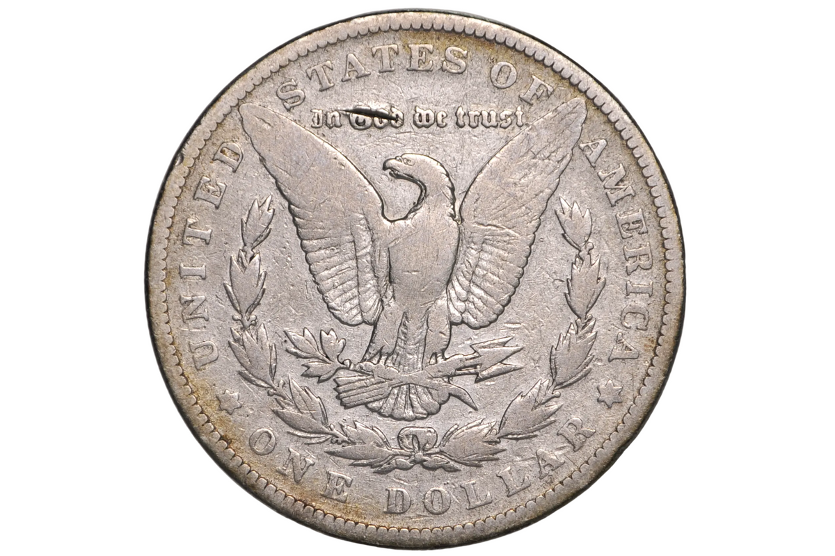 A silver US one dollar coin featuring an eagle and laurel wreath, displayed inside a clear plastic protective holder.