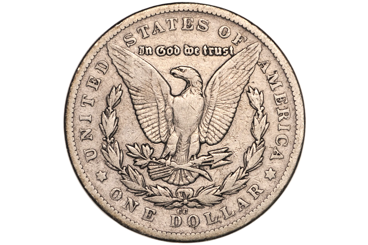 A silver US one dollar coin featuring the Great Seal with an eagle and laurel wreath, displayed inside a clear plastic protective capsule.