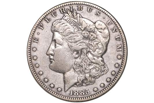 An 1885 Morgan silver dollar coin in a clear plastic protective holder, showing the Liberty head profile on the coin's face.