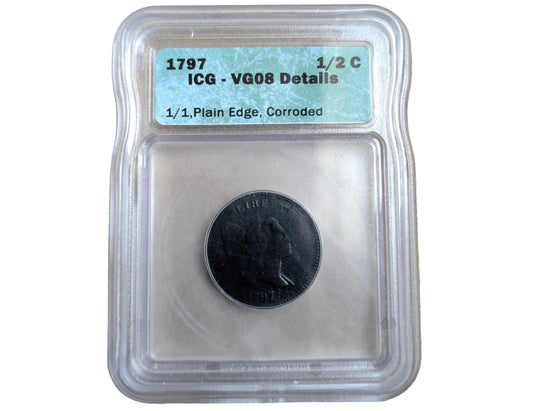A 1797 US 1/2 Cent coin graded VG08 with a clear plastic encapsulation and a light blue label, placed on a beige textured surface.