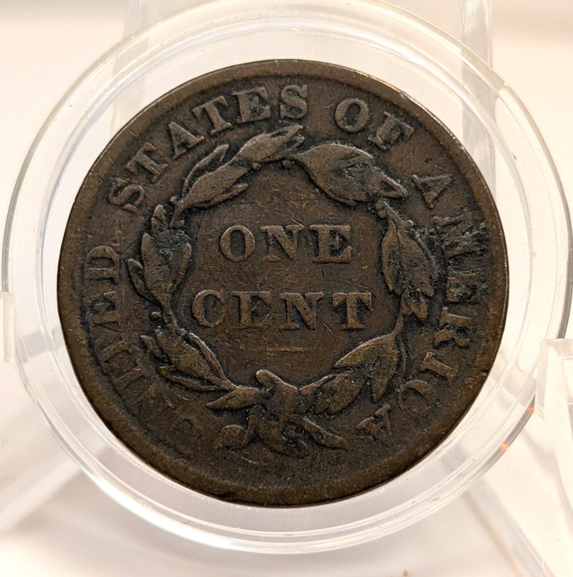Vintage one cent coin from the United States of America in a clear protective case.