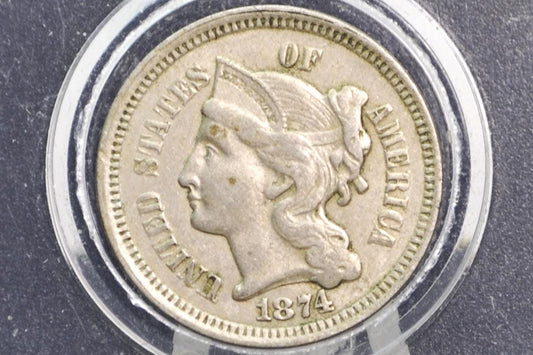 Vintage 3 cent coin with a woman's profile and 'Liberty'