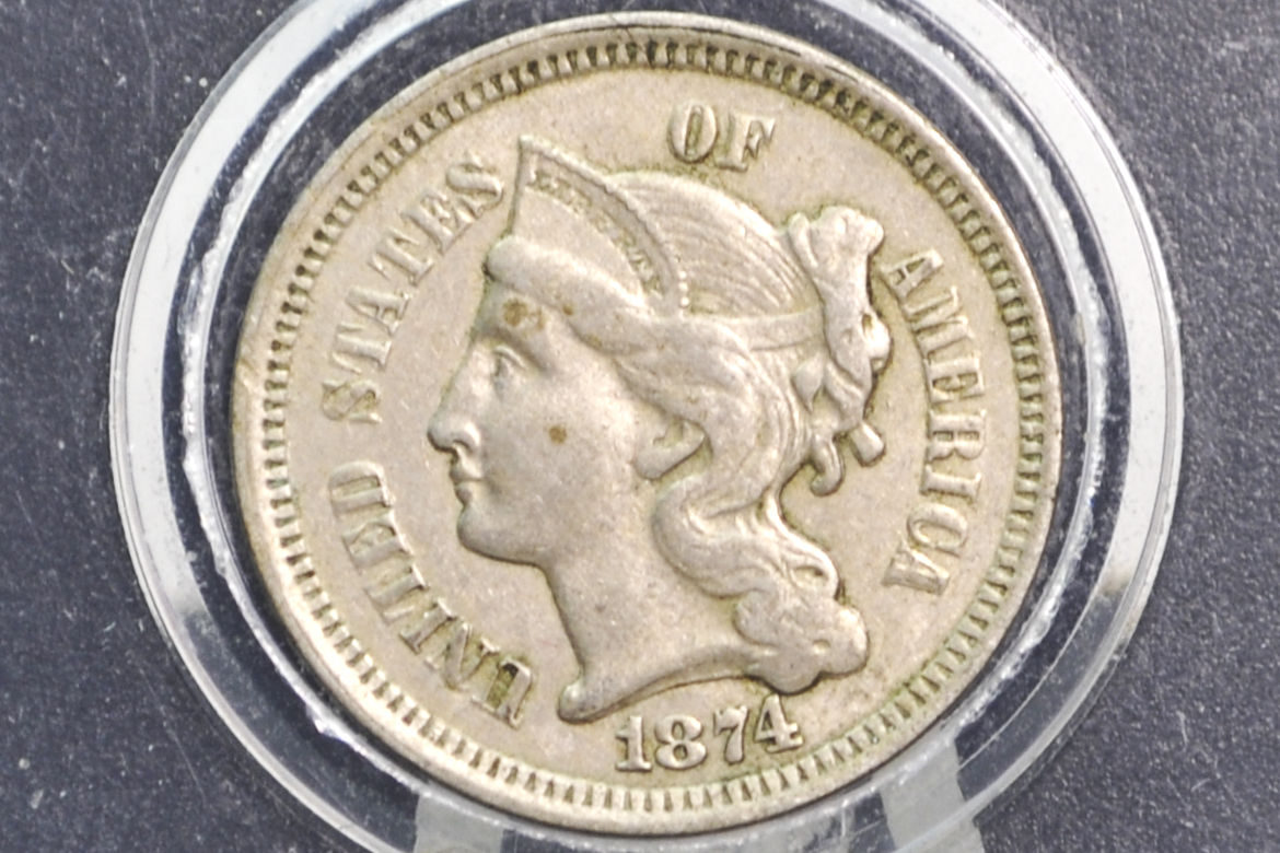 Vintage 3 cent coin with a woman's profile and 'Liberty' 