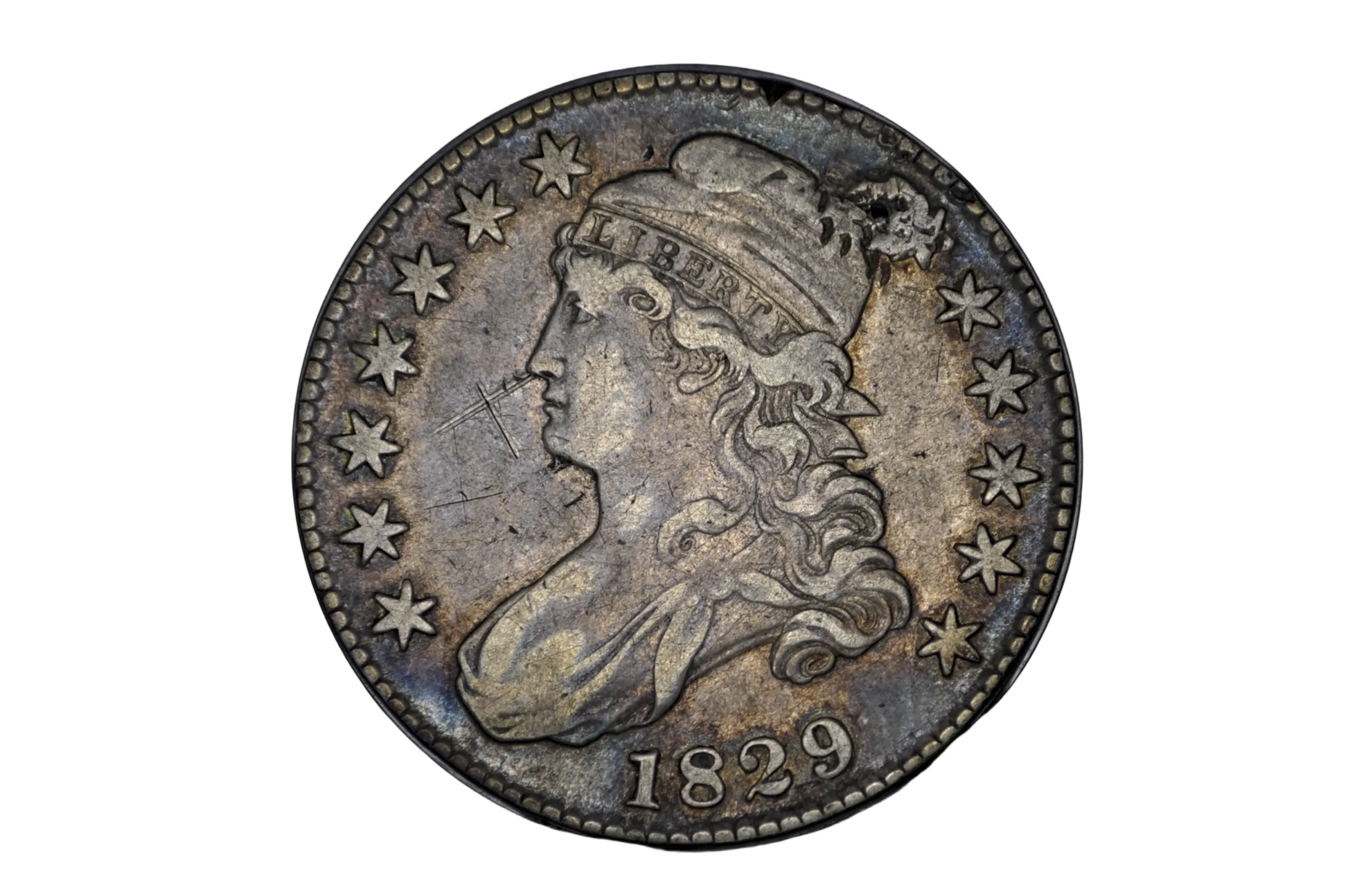 Vintage silver coin with a profile of a person and the year 1829 on a black background