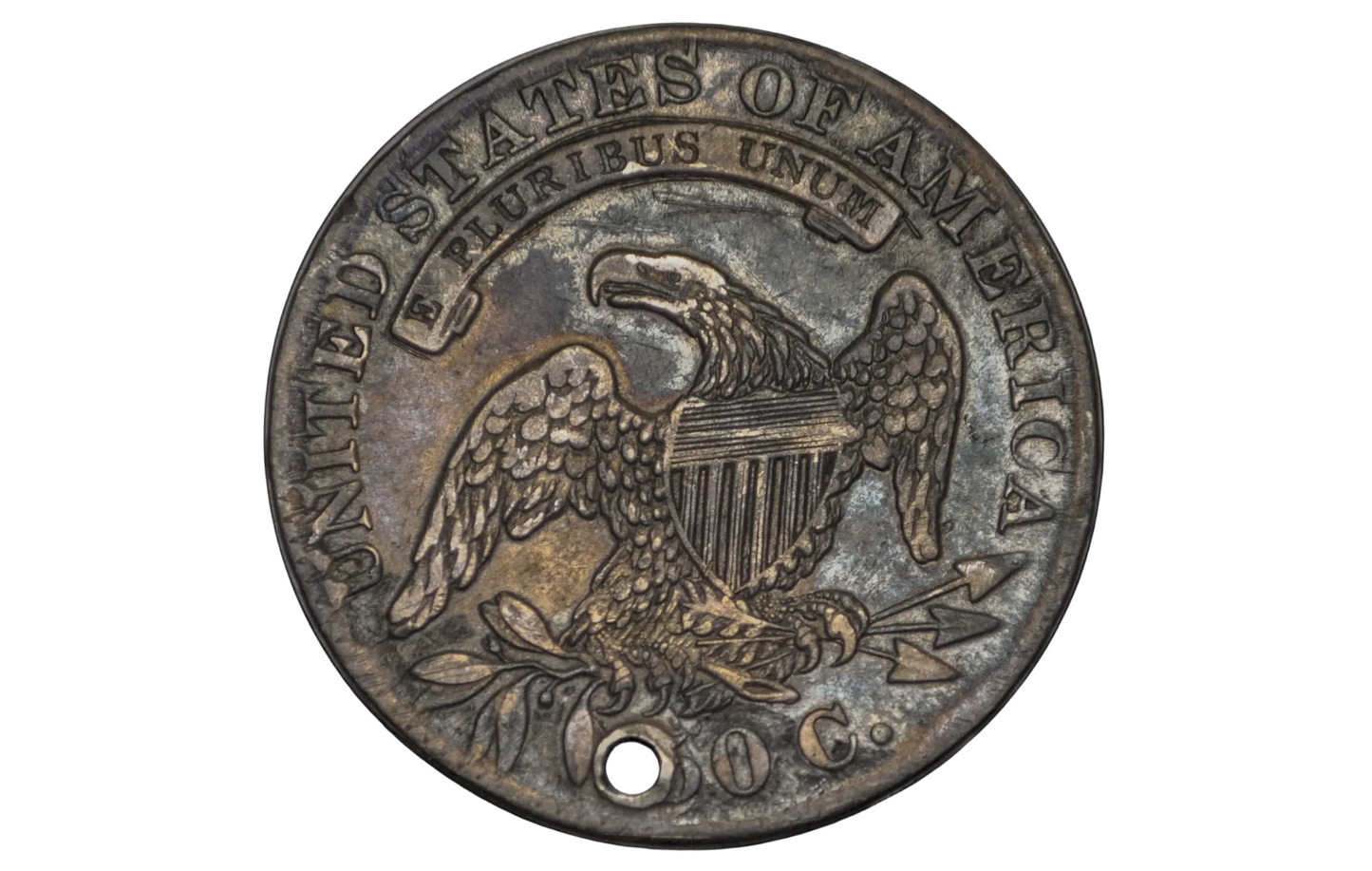 Old coin with 'United States of America' and an eagle emblem on a black background