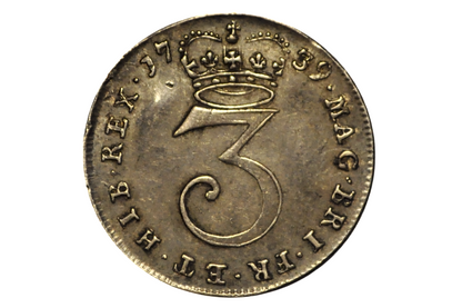 1739 three pence coin from the united kingdom. Vintage coin with a number '3' and crown design on a white background