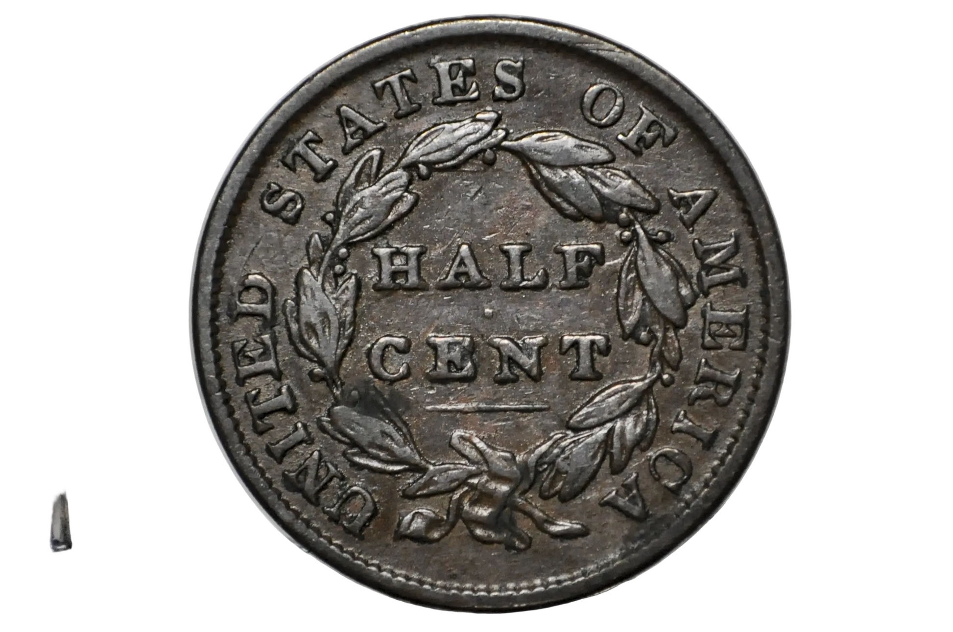 A vintage United States half cent coin with a dark metallic silver-gray patina, displayed inside a clear plastic protective capsule.