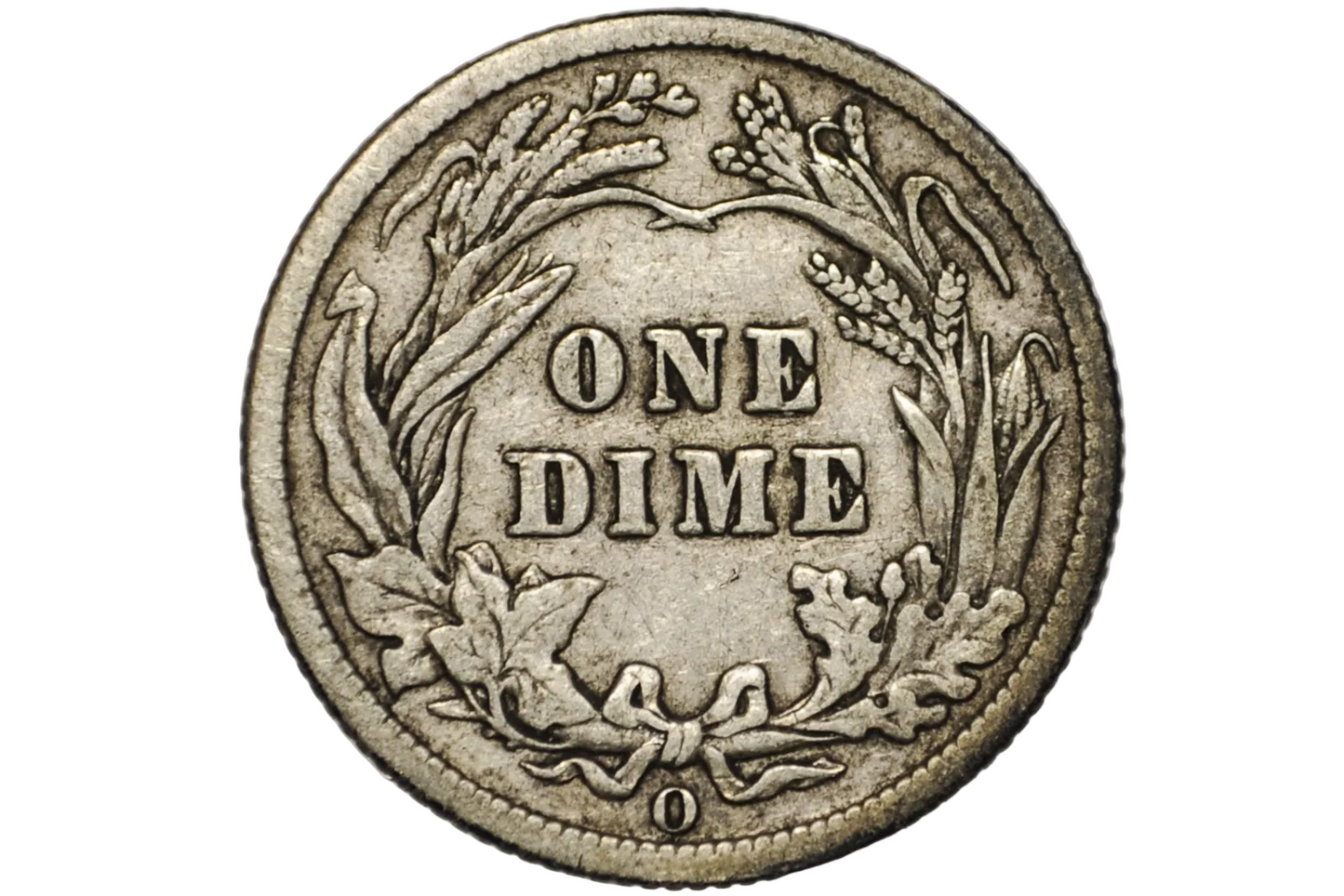 A close-up of a vintage US one dime silver coin inside a clear plastic protective capsule, showing the detailed wreath design and 'ONE DIME' text.
