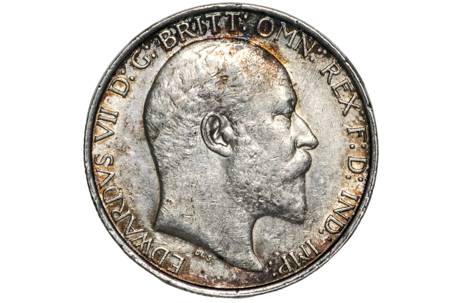 A close-up of a silver 2 shillings coin featuring a profile portrait of King Edward VII, encased in a clear plastic protective holder against a light gray background.