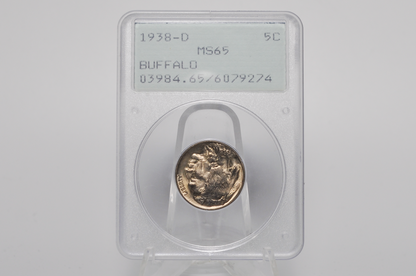 A 1938-D Buffalo nickel coin in a clear plastic grading holder with a white label, displayed on a clear stand against a light gray background.