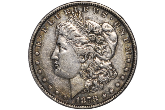 An 1878 Morgan silver dollar coin inside a clear plastic protective capsule, showing the detailed profile of Liberty with the inscription 'E PLURIBUS'.