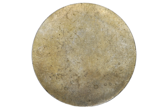 A round, textured gold-toned disc, likely a vintage coin or collectible medallion, displayed inside a clear plastic circular holder against a light gray background.