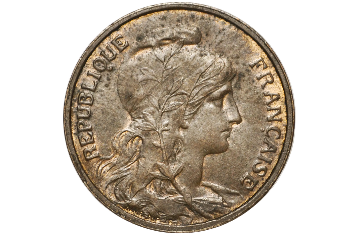 A close-up of a vintage French Republic coin featuring the profile of Liberty, with 'REPUBLIQUE FRANCAISE' inscribed around the edge, displayed inside a clear plastic protective capsule.