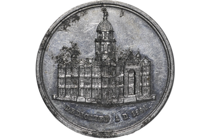 A round silver-toned commemorative coin or medallion featuring an engraved building with a dome from 1891 california