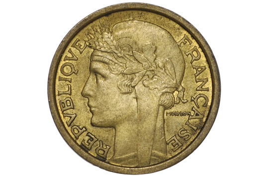 A French Republic 1 Franc coin with a golden-bronze frosty finish, encapsulated in a clear plastic protective holder against a white background.