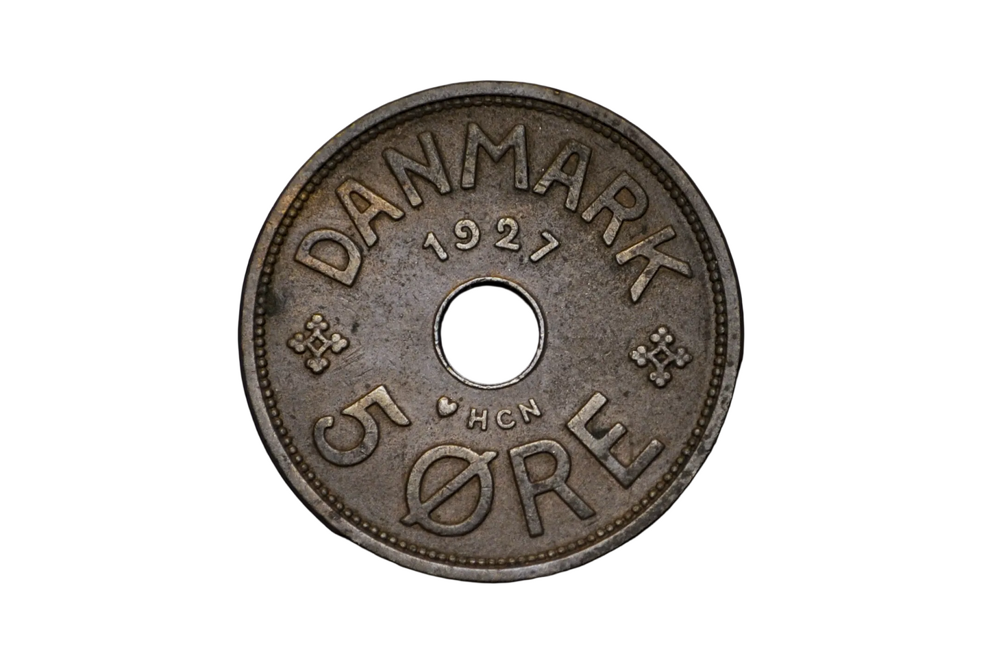 Vintage Danish coin from 1927 on a black background