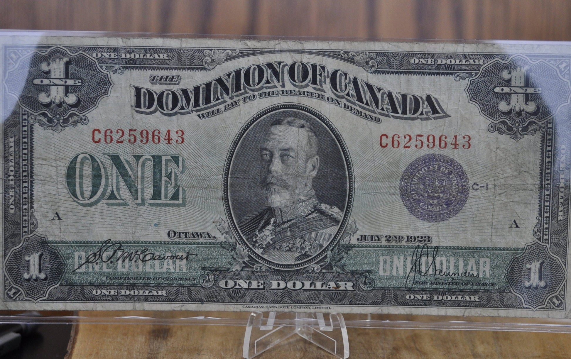 1923 One Dollar Dominion of Canada - VF (Very Fine) - Purple Seal, C Series, Very Rare Type for this Note - McCavour-Saunders - Higher Grade
